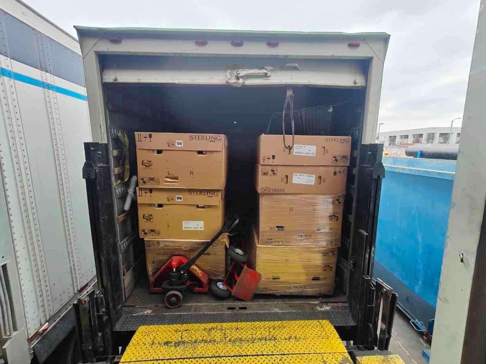 Inside a Curri fleet box truck loaded with stacked boxes ready for a same-day commercial delivery