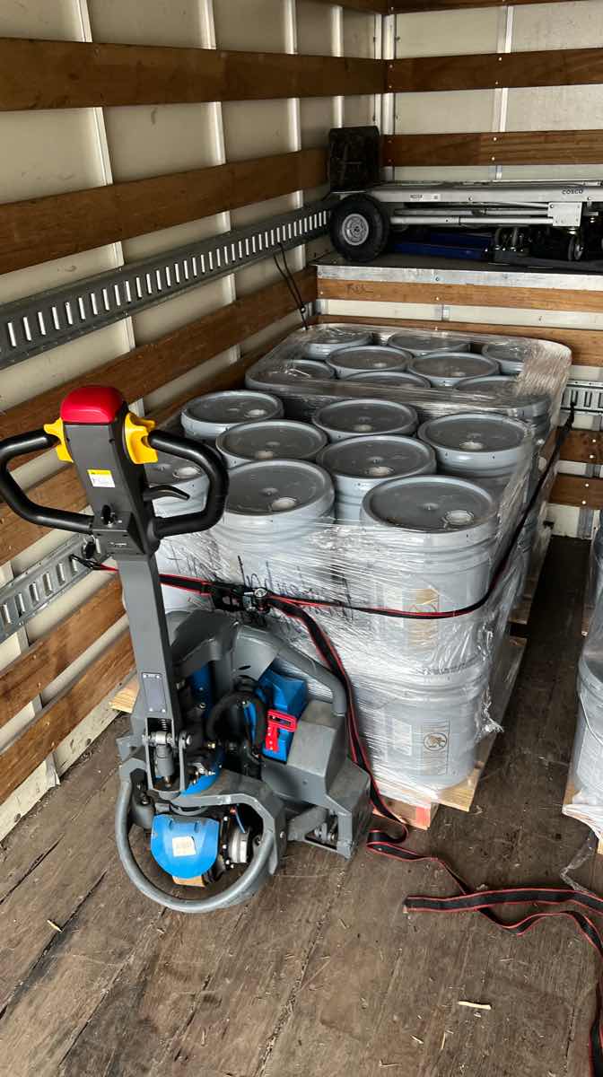Pallet of cargo strapped and shrink-wrapped on a Curri box truck route