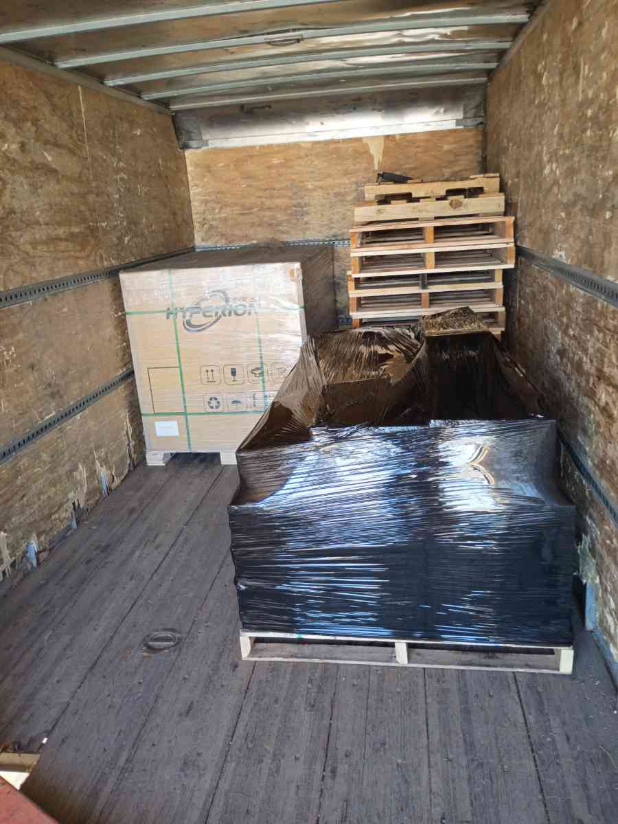 Curri box truck backed into a commercial loading dock for pickup