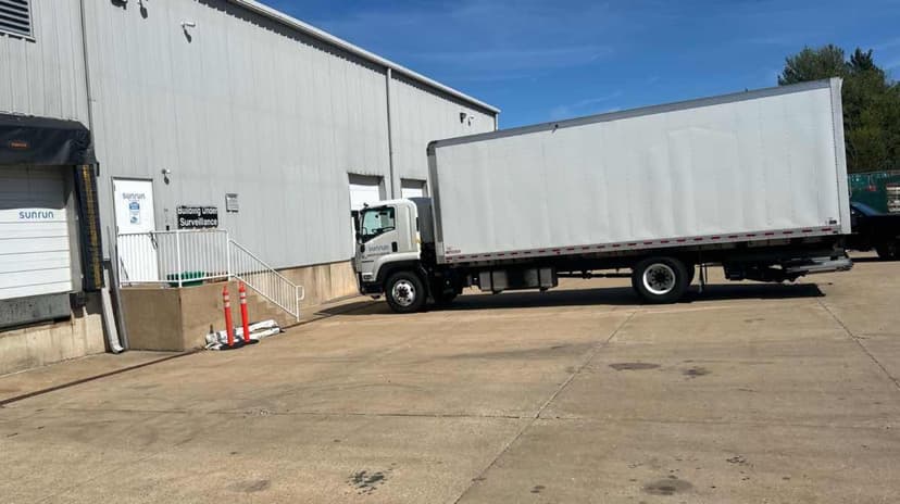 White Curri fleet box truck staged at a distribution warehouse for same-day dispatch