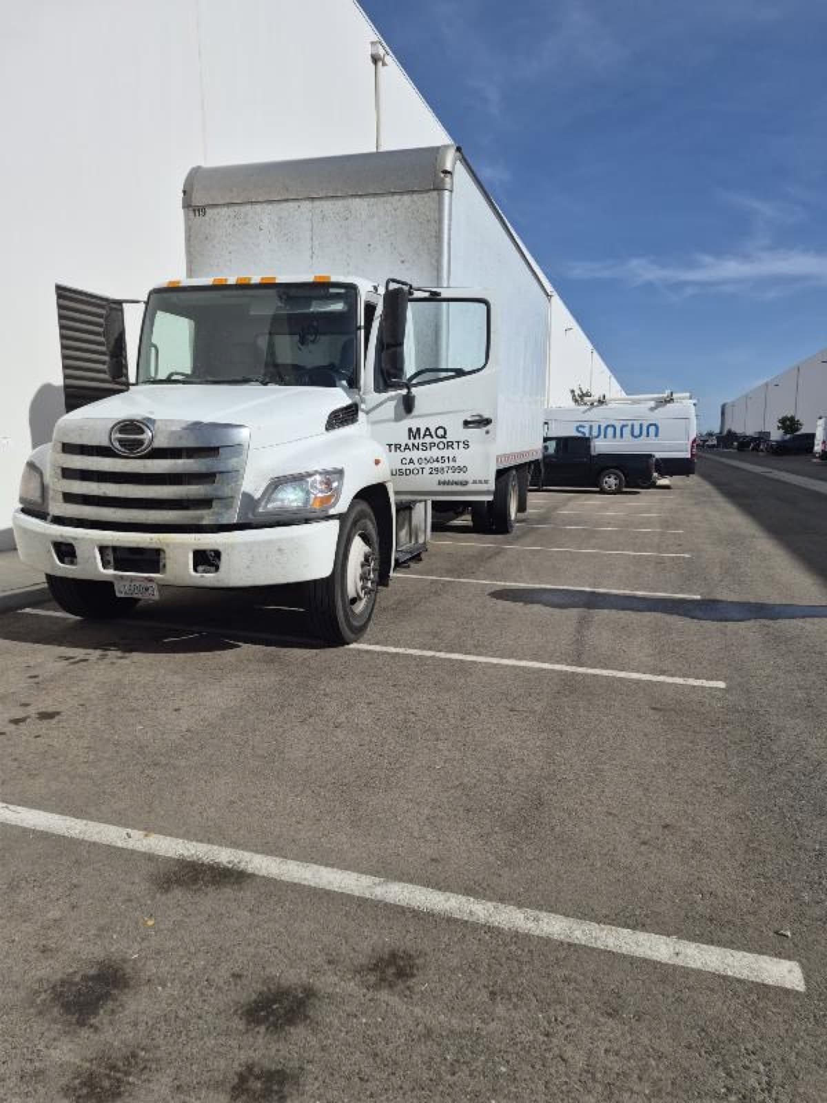 Curri-vetted box truck driver on the job ready for a large same-day delivery