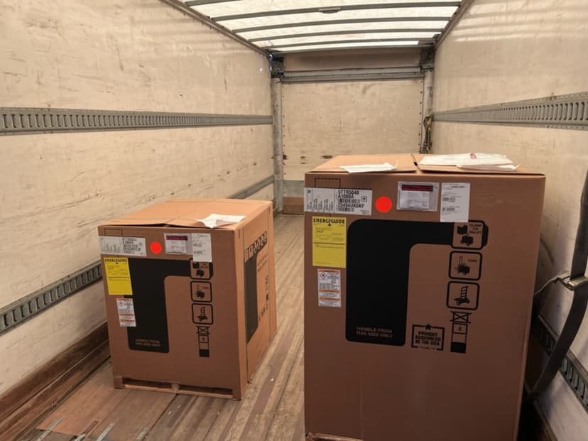 Boxes stacked floor-to-ceiling inside a box truck cargo bay