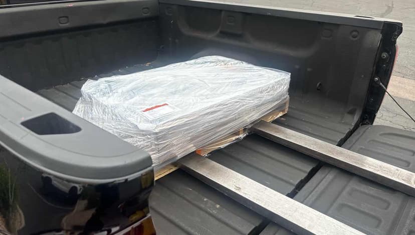 Wrapped pallet secured in a pickup truck bed ready for a Curri last-mile drop-off
