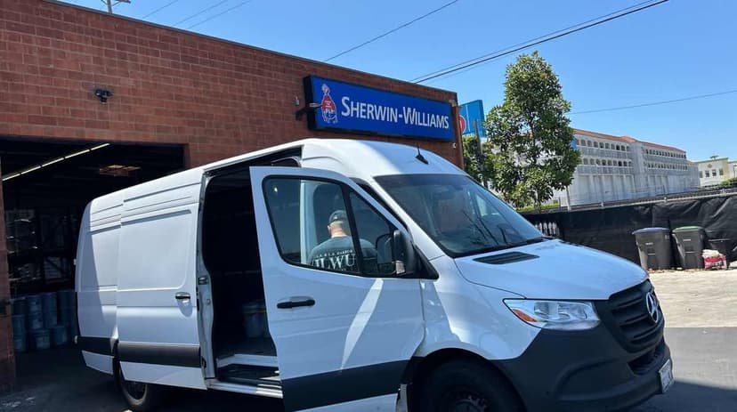 White Mercedes-Benz Sprinter Van at a Sherwin-Williams paint counter for a Curri same-day trade pickup