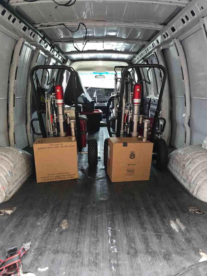Cargo Sprinter Van interior loaded with paint sprayers and a wheeled cart for a Curri multi-stop trade run