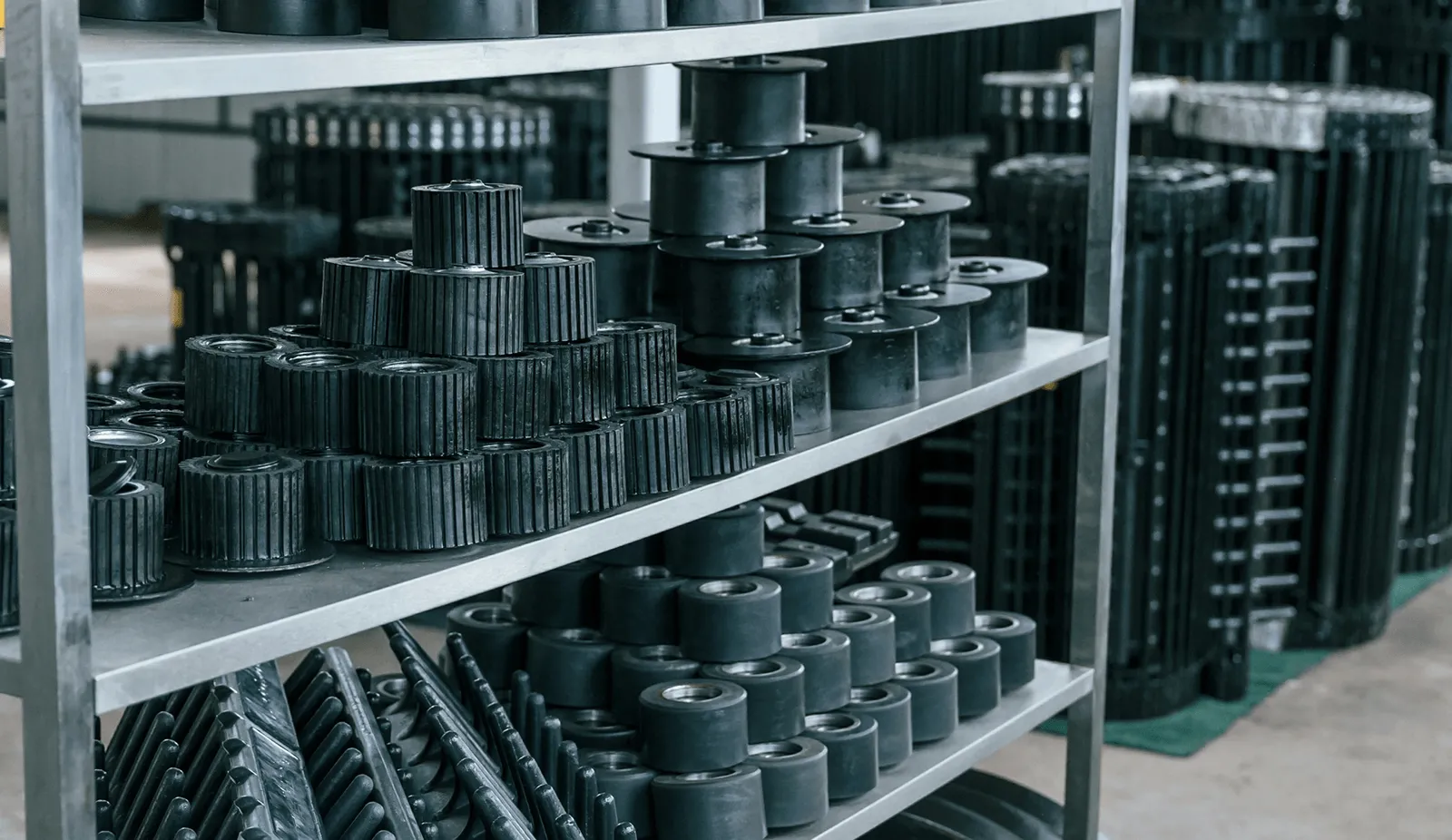 Warehouse shelving stacked with automotive gears, pulleys, and drivetrain parts ready for distribution—Curri's fleet moves this inventory to repair shops, tire dealers, and auto parts counters across town same-day.