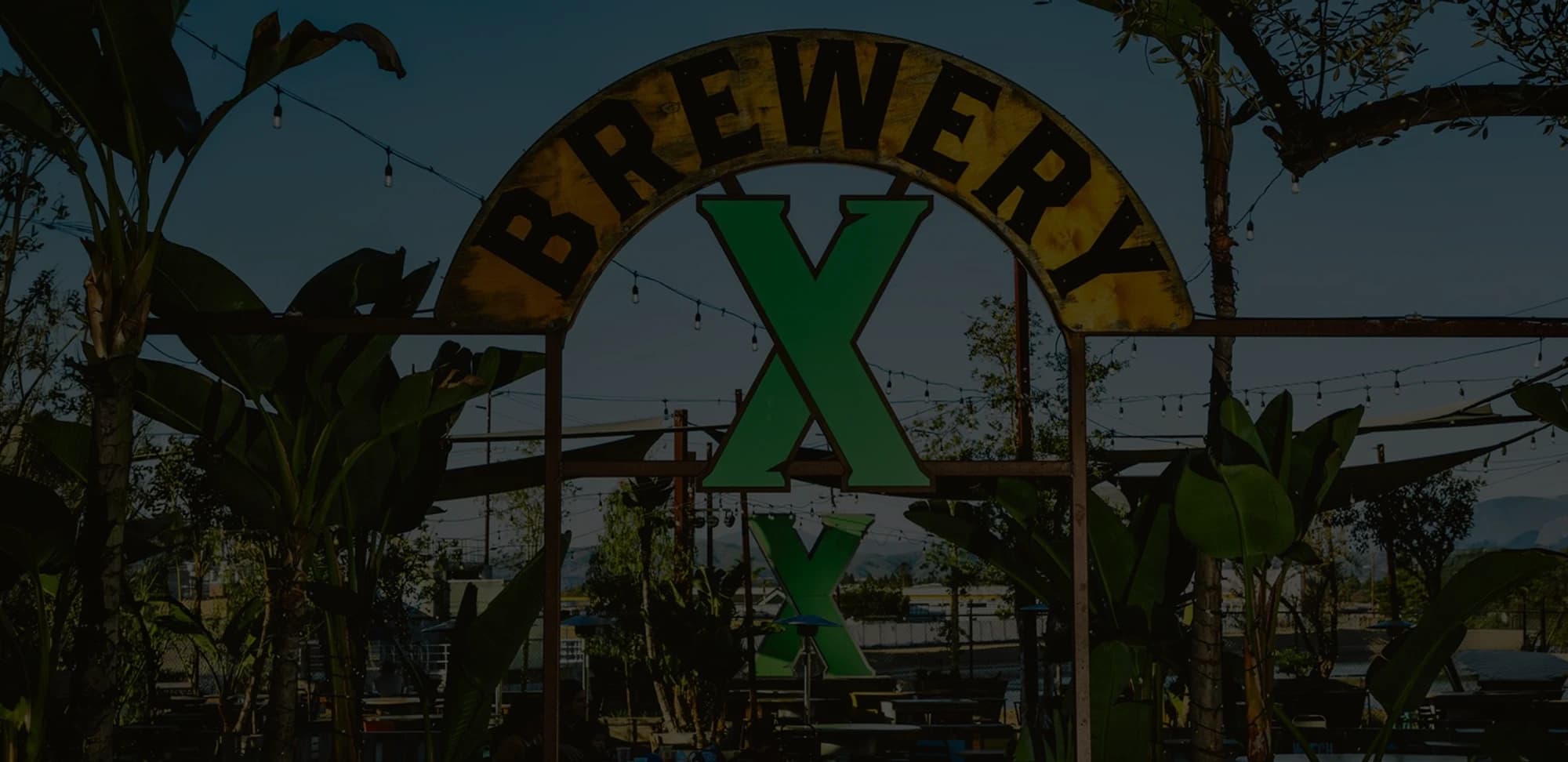 The Brewery X sign over the patio in Anaheim, under strings of lights