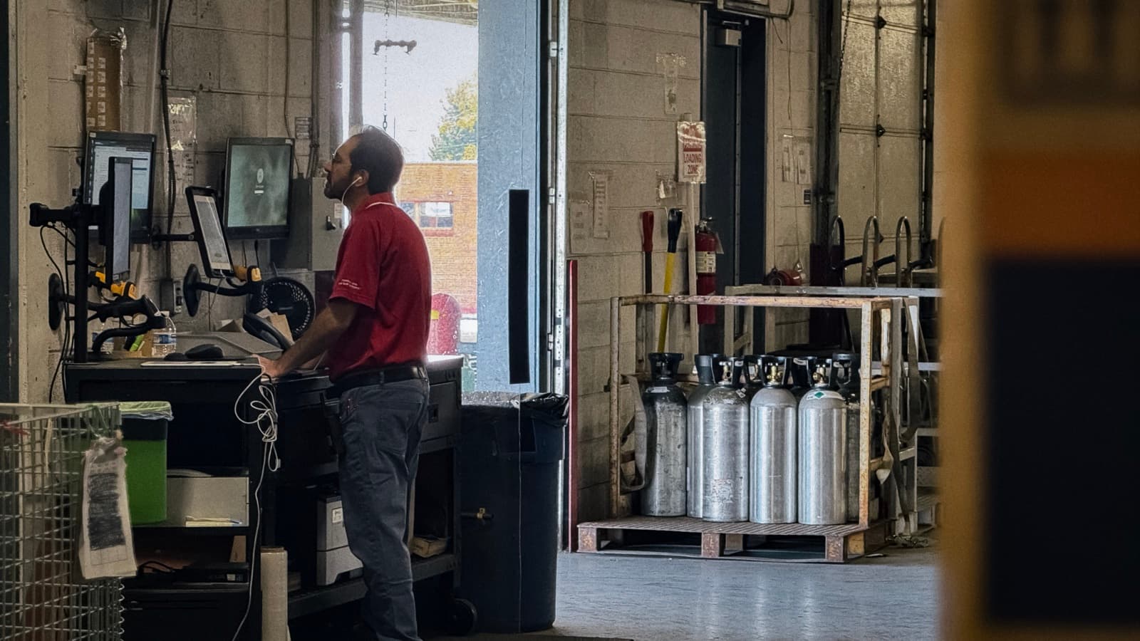 Curri distribution operations worker managing a manual supply chain inside a building materials warehouse